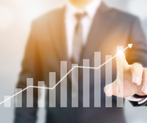 Businessman pointing at rising graph