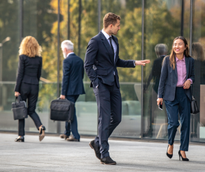 Business professionals walking and talking outside office building.