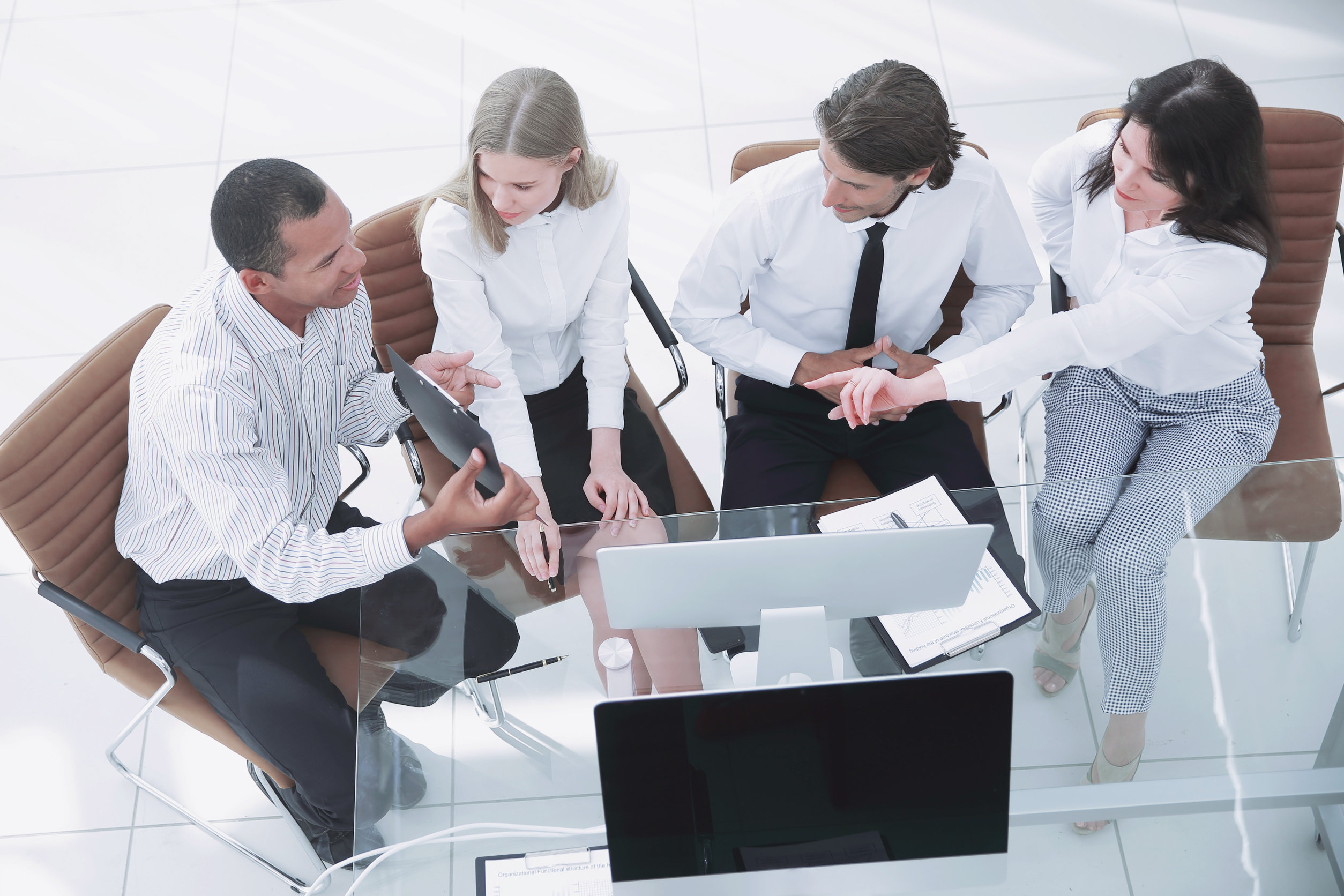 Team meeting with digital tablet and computers.