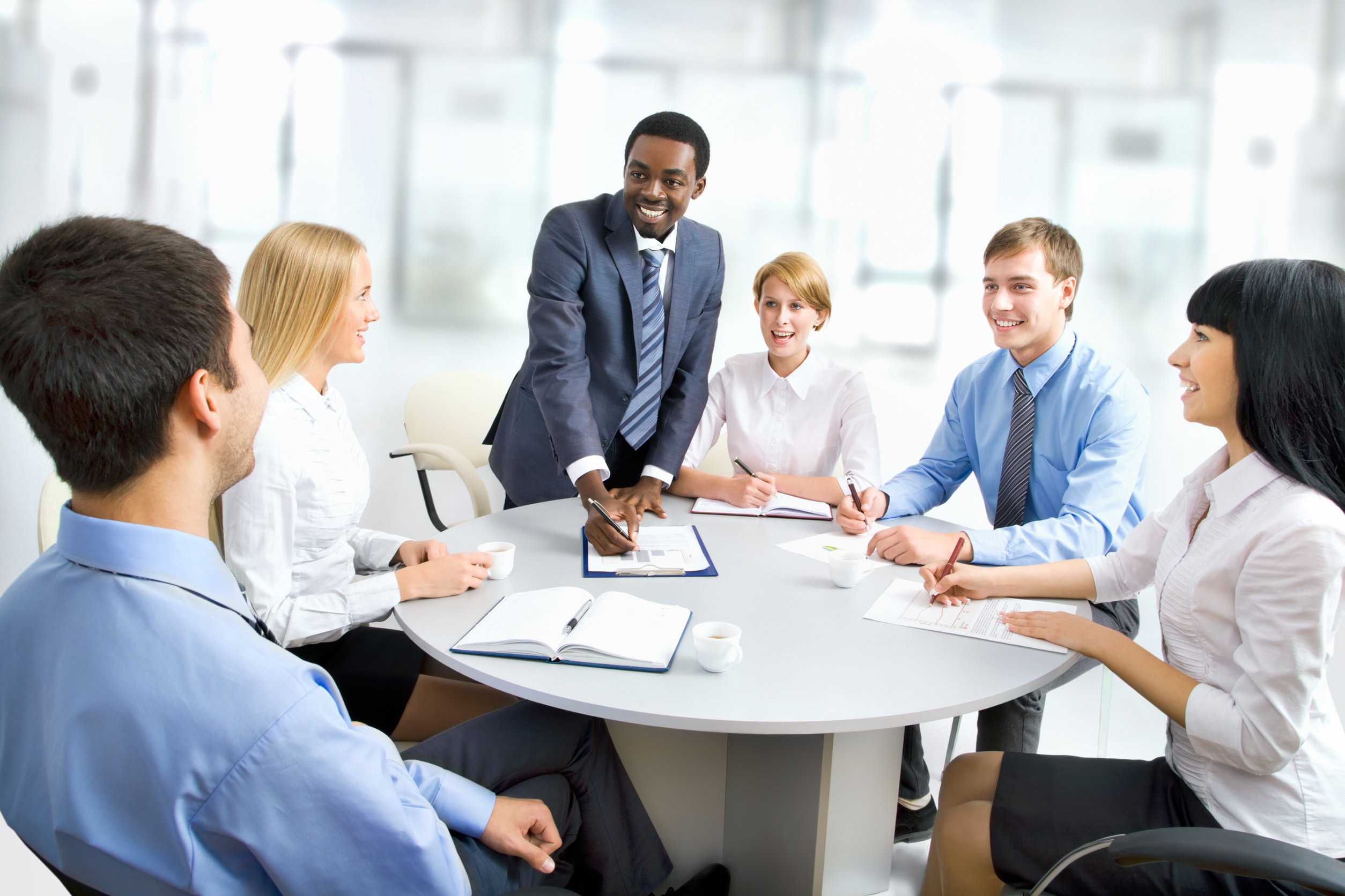 Diverse team meeting in bright office space.