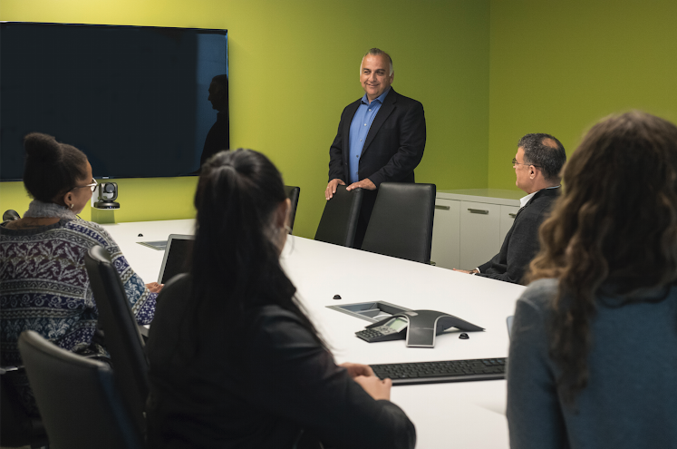 Business meeting in progress with presenter and attendees.