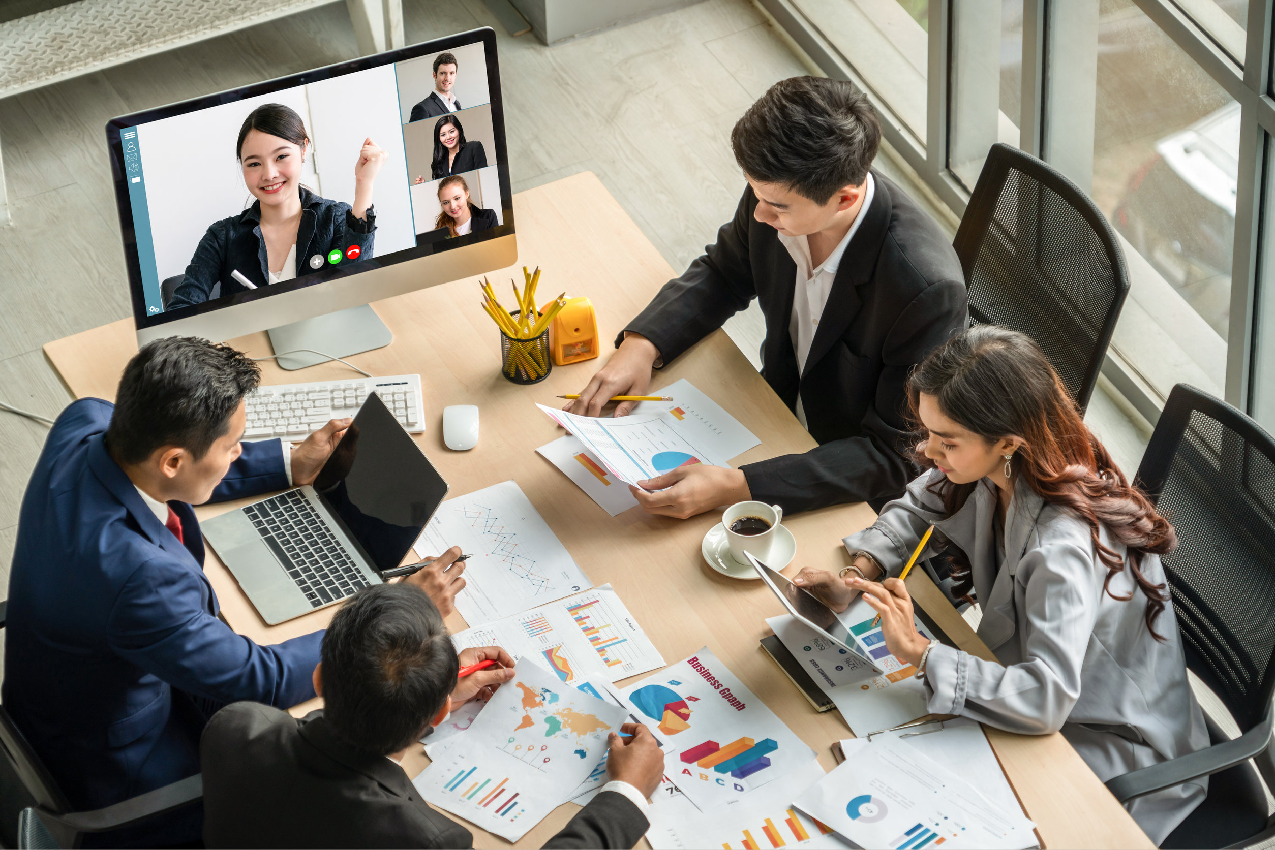 Team meeting with video conference and analytics discussion.