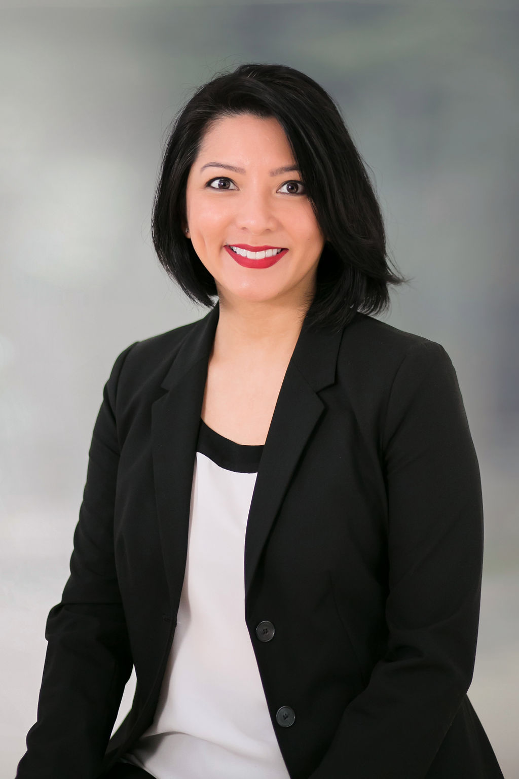 Professional woman smiling in business attire.