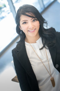 Smiling woman in business attire indoors.