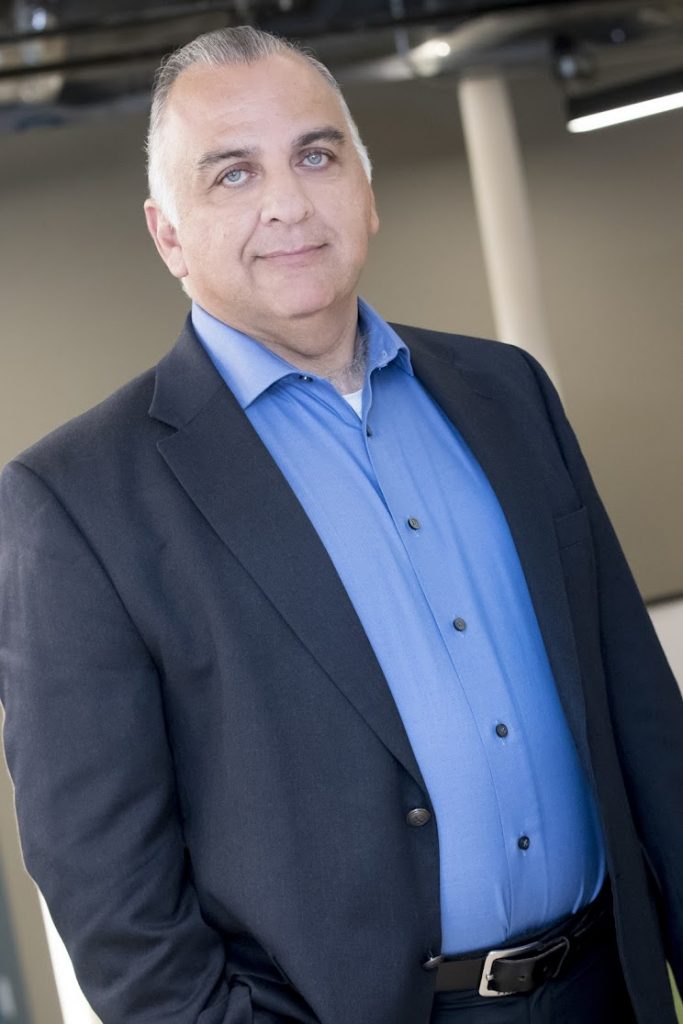 Professional man in suit with blue shirt indoor.