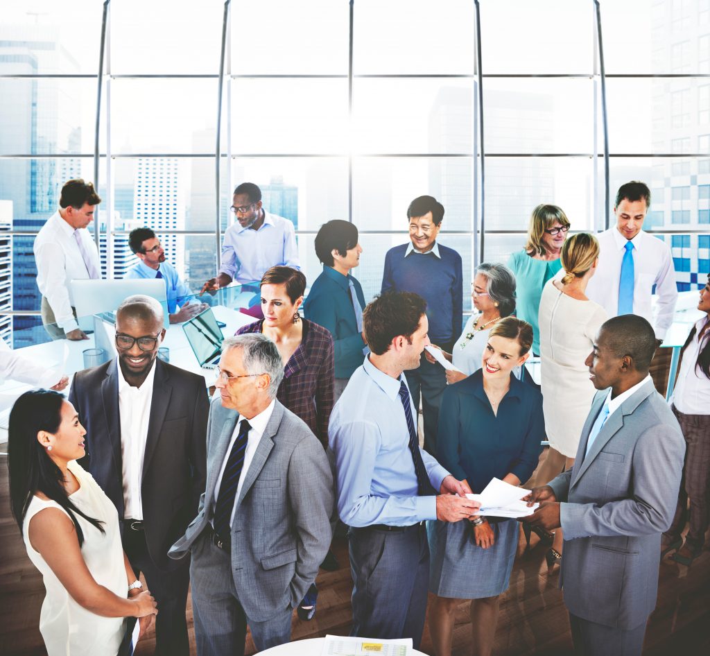 Diverse business professionals networking in modern office setting.