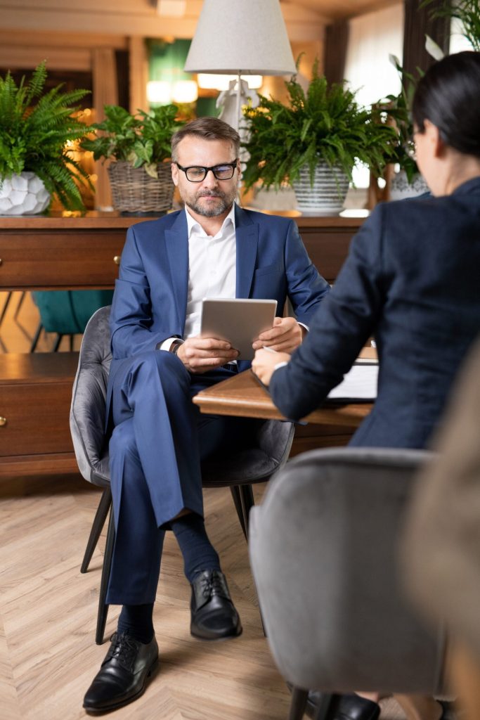 Business meeting with tablet and professional attire.