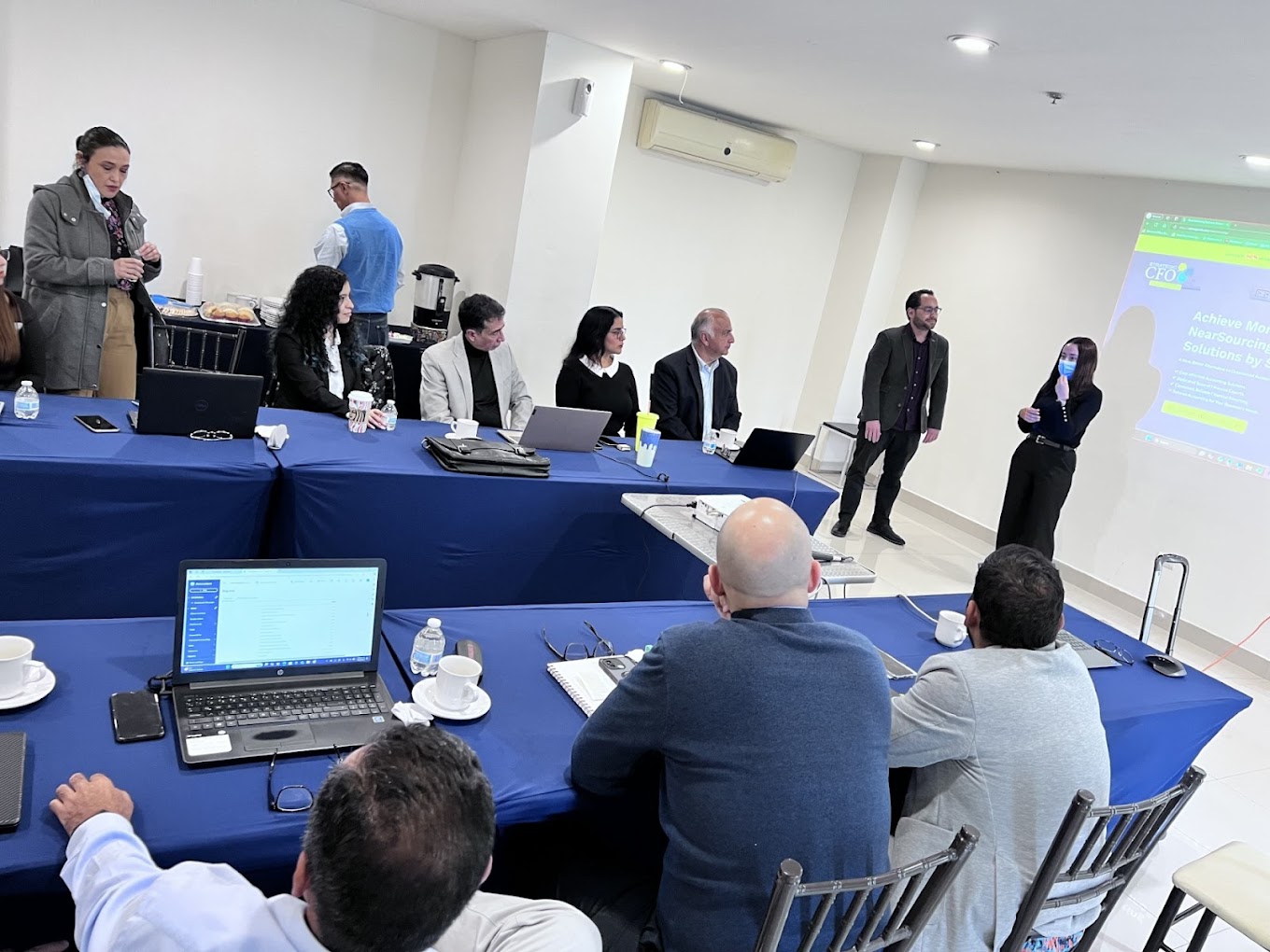 Business meeting with presentation and laptops.