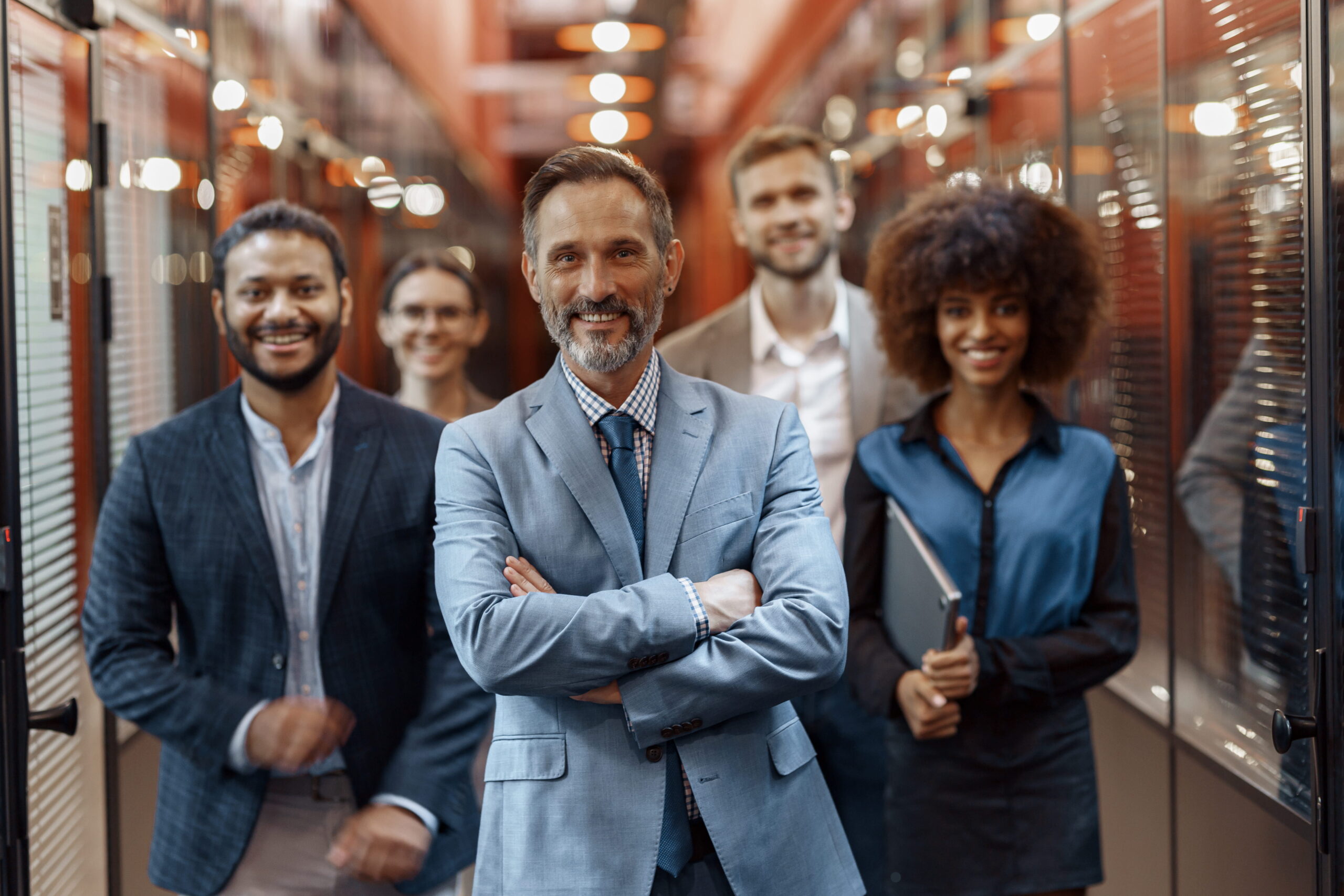 Diverse business team smiling in office corridor
