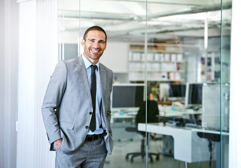 Man in suit smiling in modern office