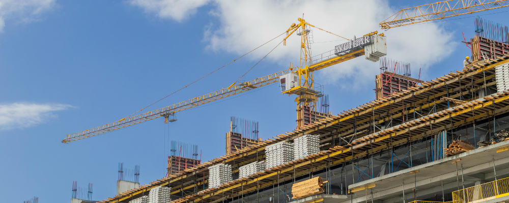 Tower crane above building under construction